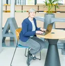 Manon, chargée de l’administration, travaillant sur un ordinateur dans un bureau.
